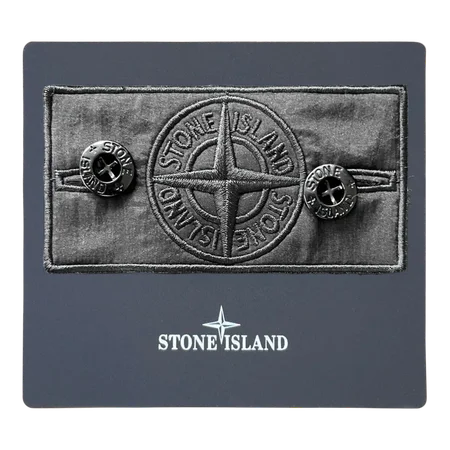 Front view of shadow project badge with compass design